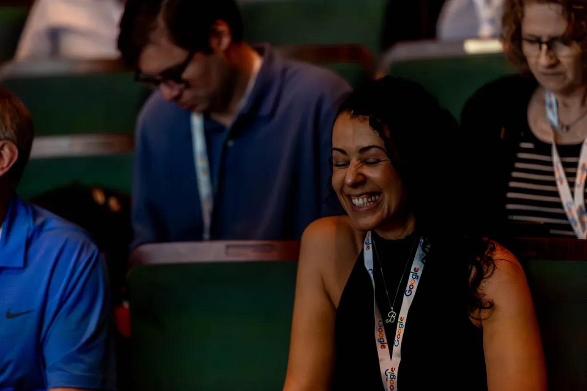 Smiling attendee during a session at All Things AI 2026
