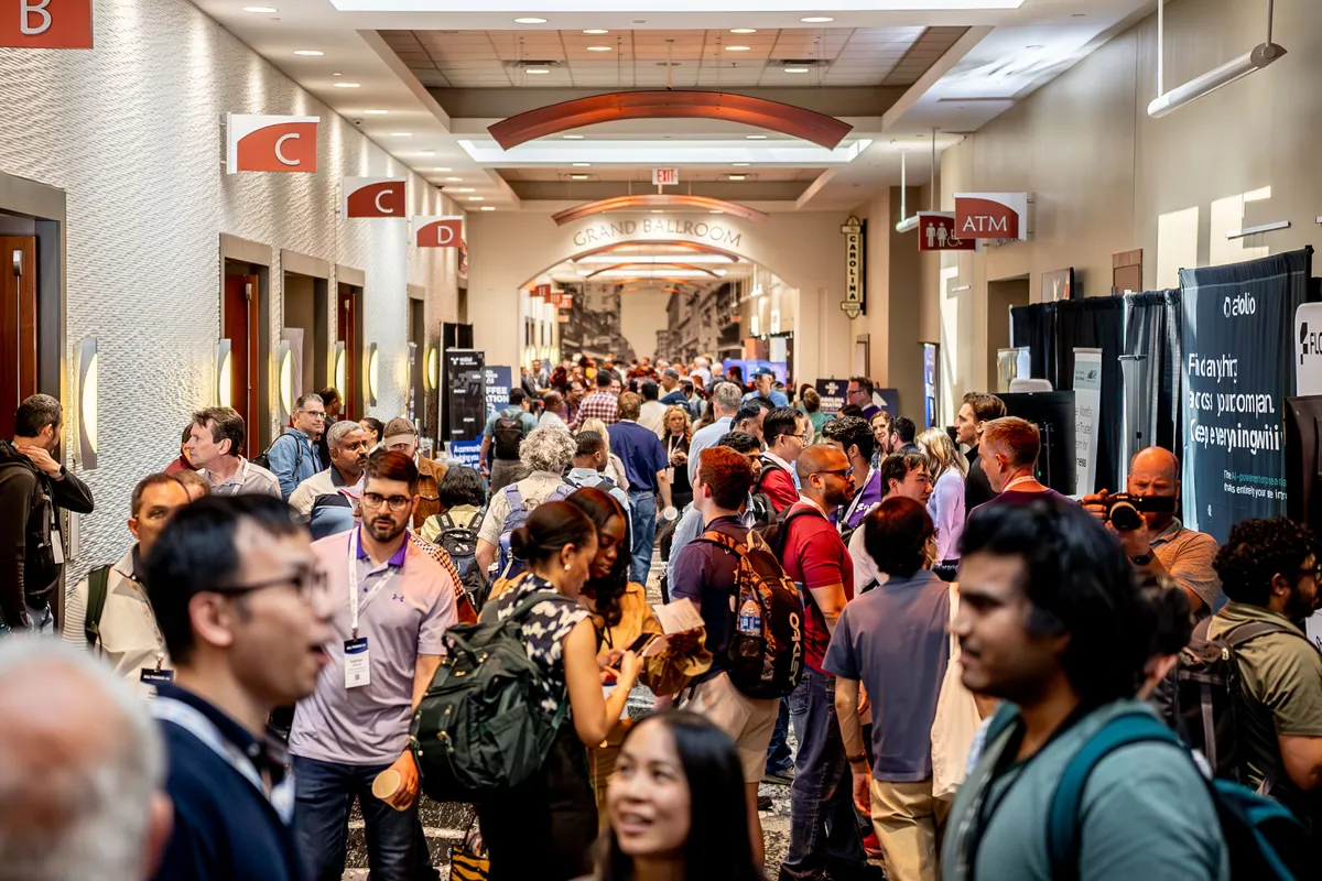 Attendees networking in the lobby at All Things AI 2026