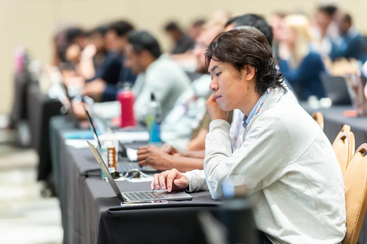 Attendees working with laptops open during an All Things AI 2026 workshop